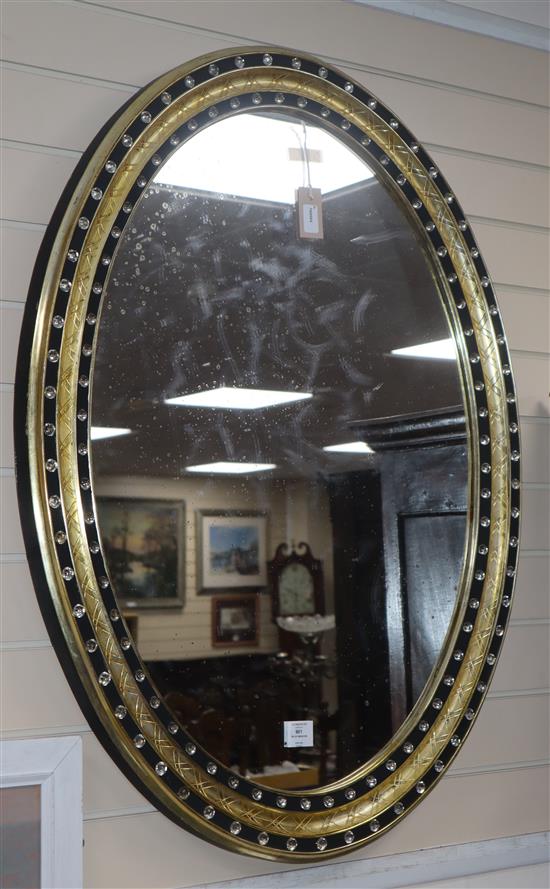 A pair of Irish style oval mirrors with glass-mounted gilt and ebonised frames H.105cm